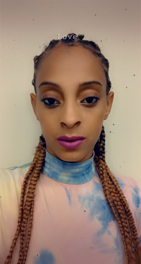 Customer with medium skin tone showcasing a vibrant, bold, long-lasting matte lipstick without drying out lips.
